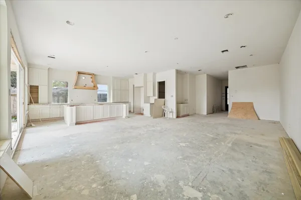 a large white bedroom with kitchen