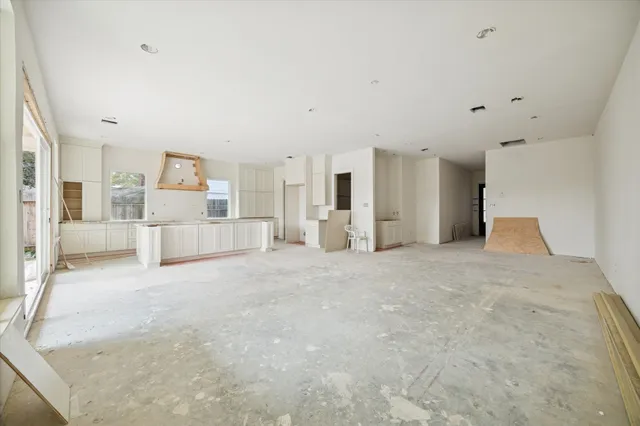 a large white bedroom with kitchen