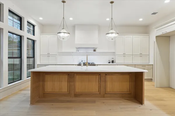 a kitchen with a sink cabinets and window