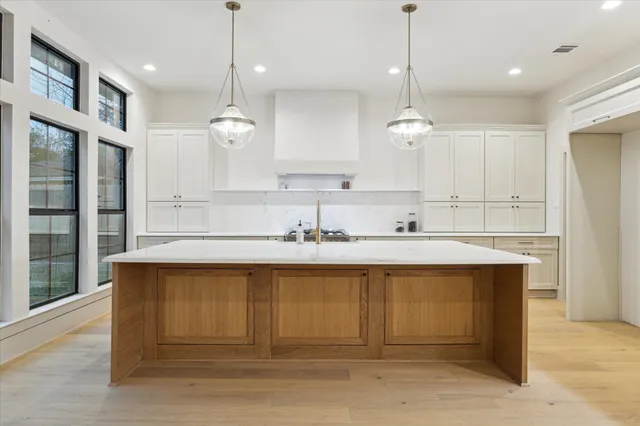 a kitchen with a sink cabinets and window