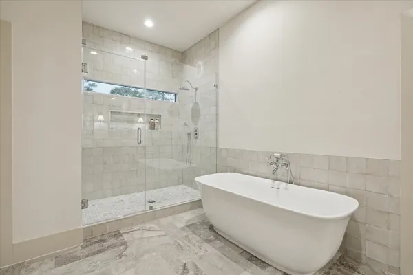 a bathroom with a bathtub and shower