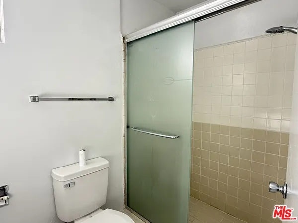a bathroom with a toilet and a shower