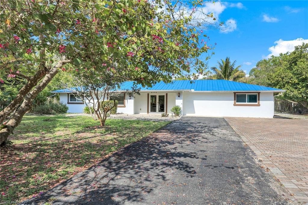 5175 Green Boulevard Naples, FL 34116 - Photo 32 of 43 a front view of a house with a garden