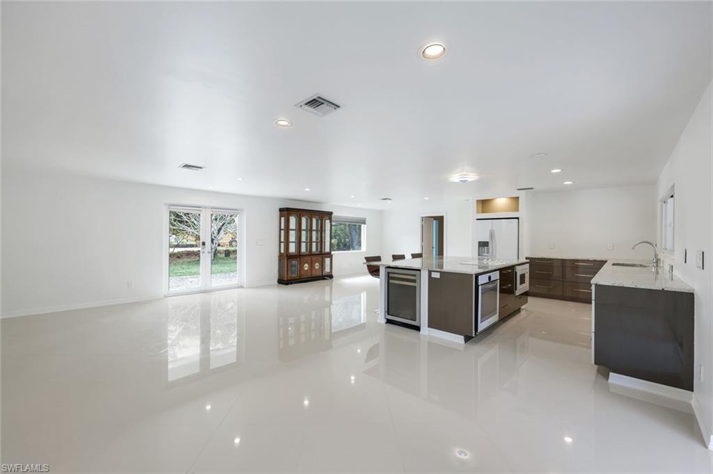 5175 Green Boulevard Naples, FL 34116 - Photo 8 of 43 a view of a living room kitchen and a window