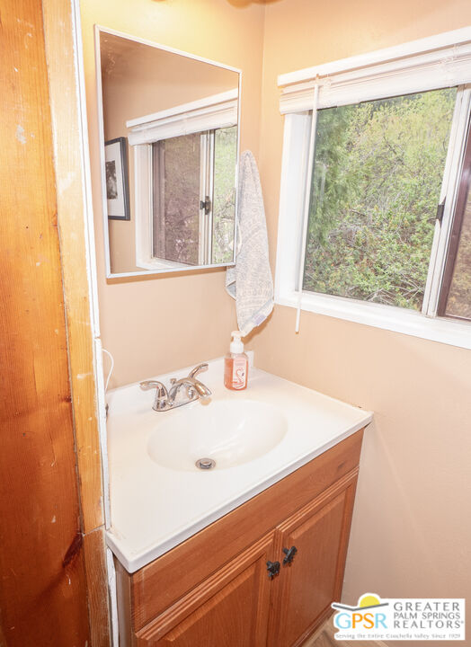 69 7 Oaks Road Angelus Oaks, CA 92305 - Photo 15 of 36 a bathroom with a sink and a window