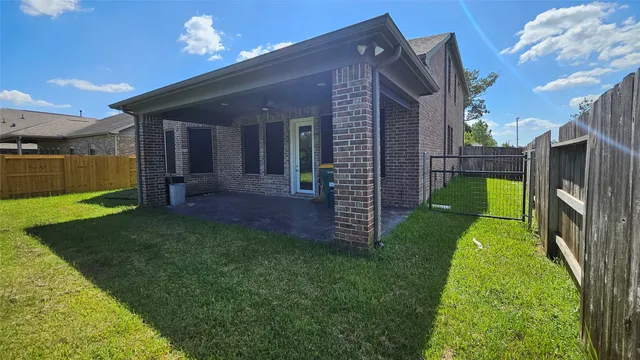 a view of a house with a porch and a yard