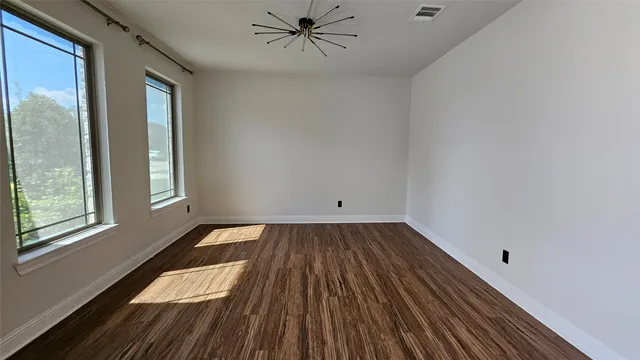a view of a livingroom with wooden floor and a window