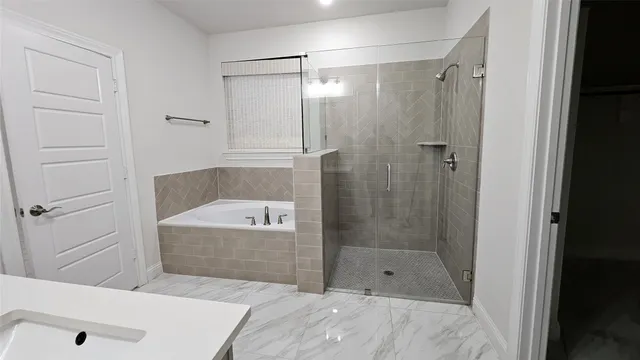a bathroom with a bathtub and shower