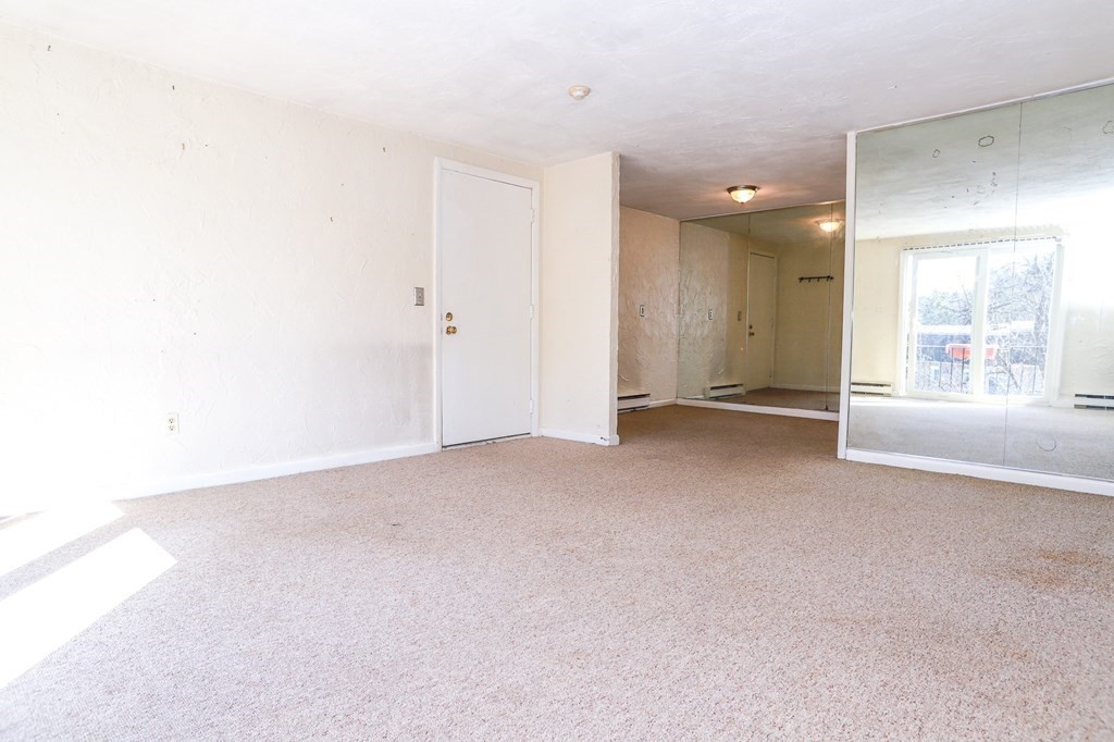 202 Swanson Road, Unit 524 Boxborough, MA 01719 - Photo 13 of 22 a view of a big room with windows and chandelier fan