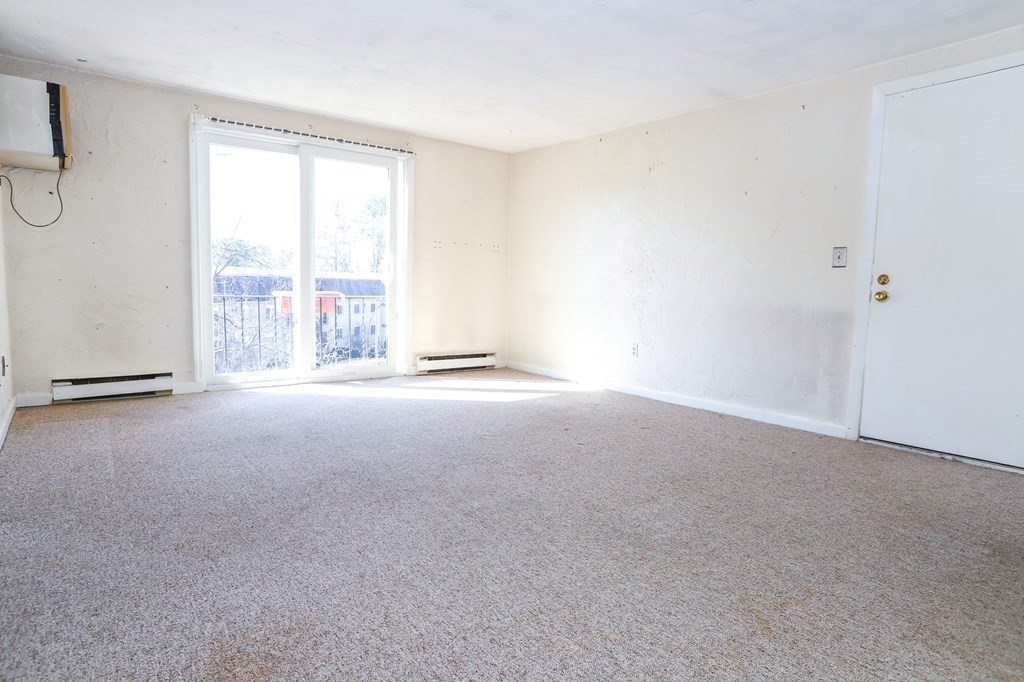 202 Swanson Road, Unit 524 Boxborough, MA 01719 - Photo 15 of 22 a view of room with floor to ceiling windows