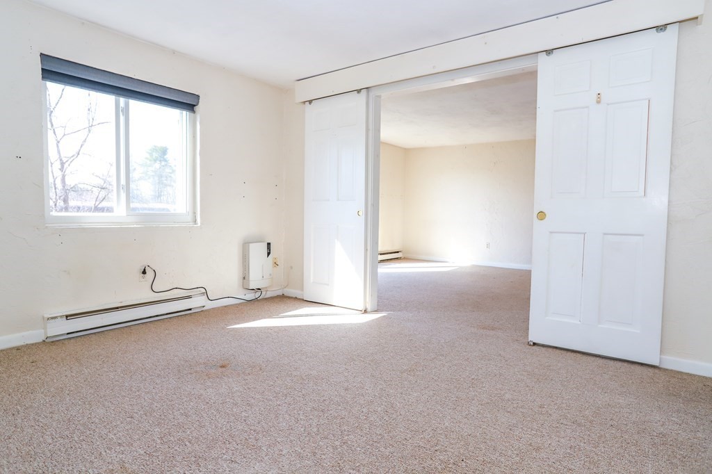 202 Swanson Road, Unit 524 Boxborough, MA 01719 - Photo 17 of 22 a view of an empty room with a window