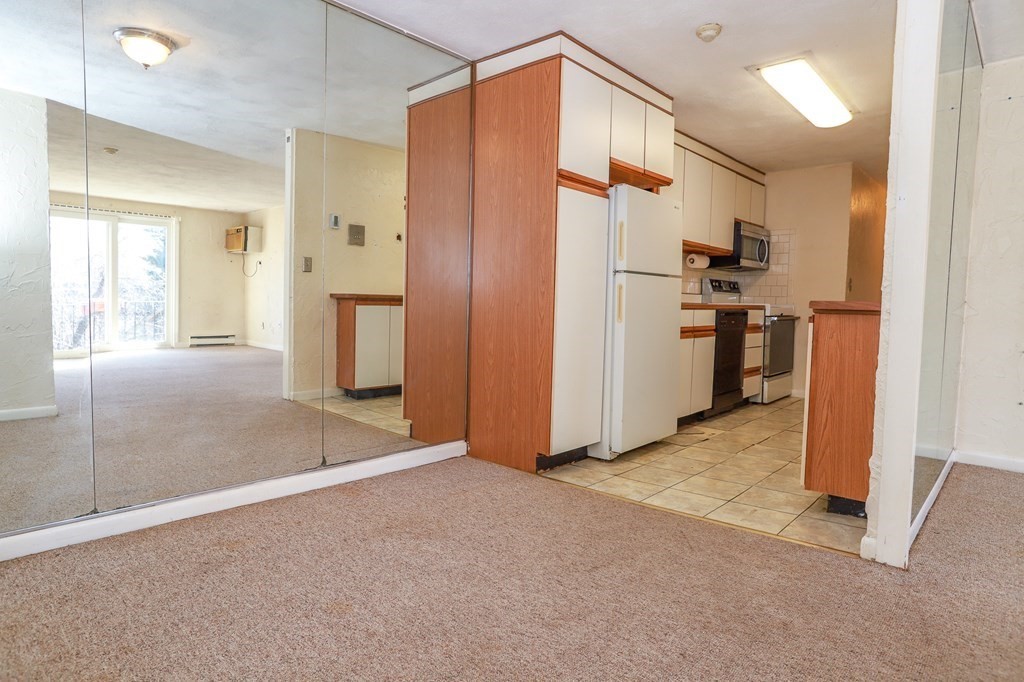 202 Swanson Road, Unit 524 Boxborough, MA 01719 - Photo 4 of 22 a view of a kitchen with a refrigerator and a sink
