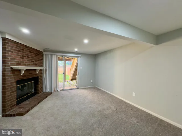 a view of empty room with a fireplace