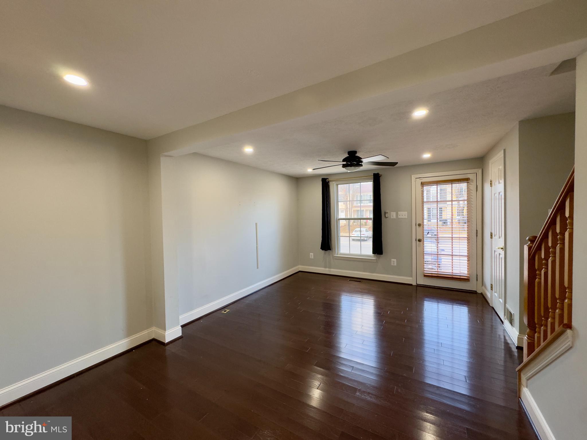 2209 Riding Crop Way Baltimore, MD 21244 - Photo 14 of 20 a view of an empty room with wooden floor and a window