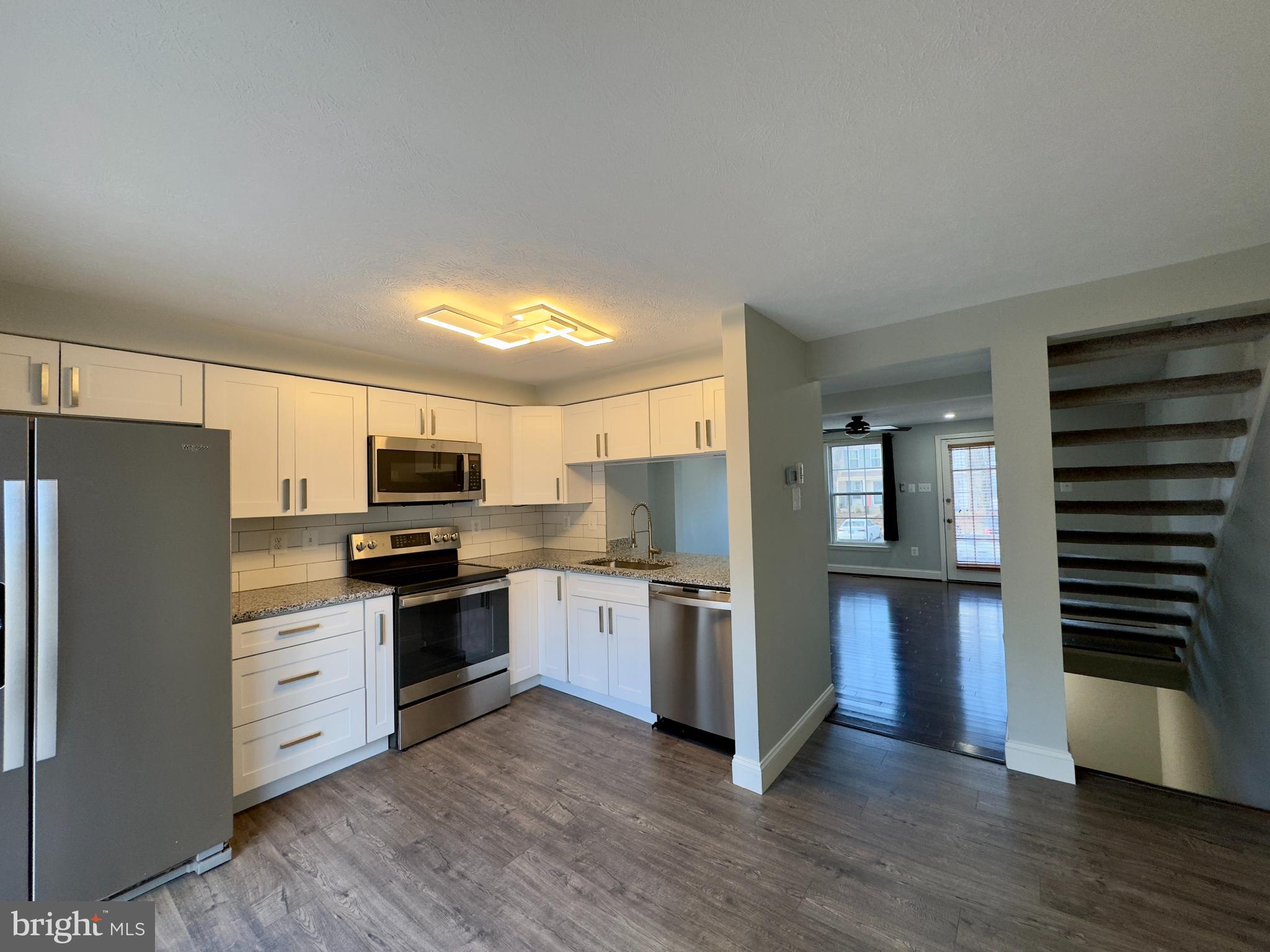 2209 Riding Crop Way Baltimore, MD 21244 - Photo 17 of 20 a kitchen with stainless steel appliances a refrigerator stove and sink