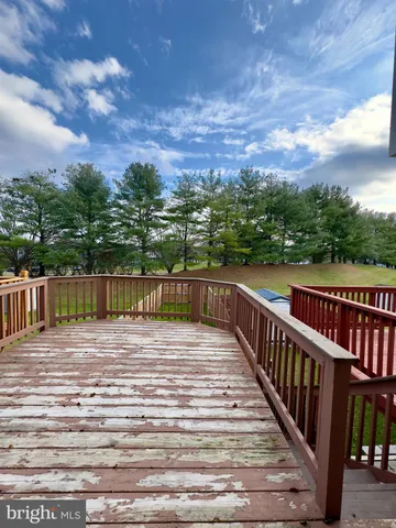 a view of a balcony with wooden floor and city view