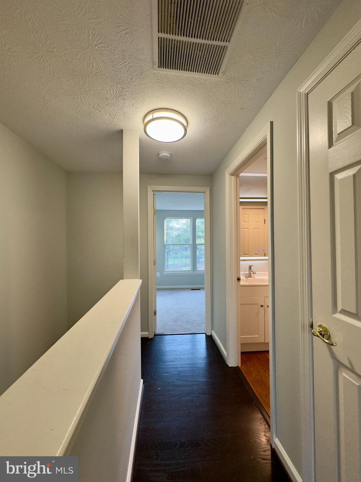 2209 Riding Crop Way Baltimore, MD 21244 - Photo 19 of 20 a view of a hallway with wooden floor