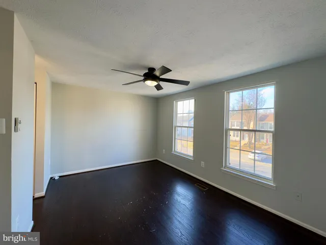 a view of wooden floor and windows in a room