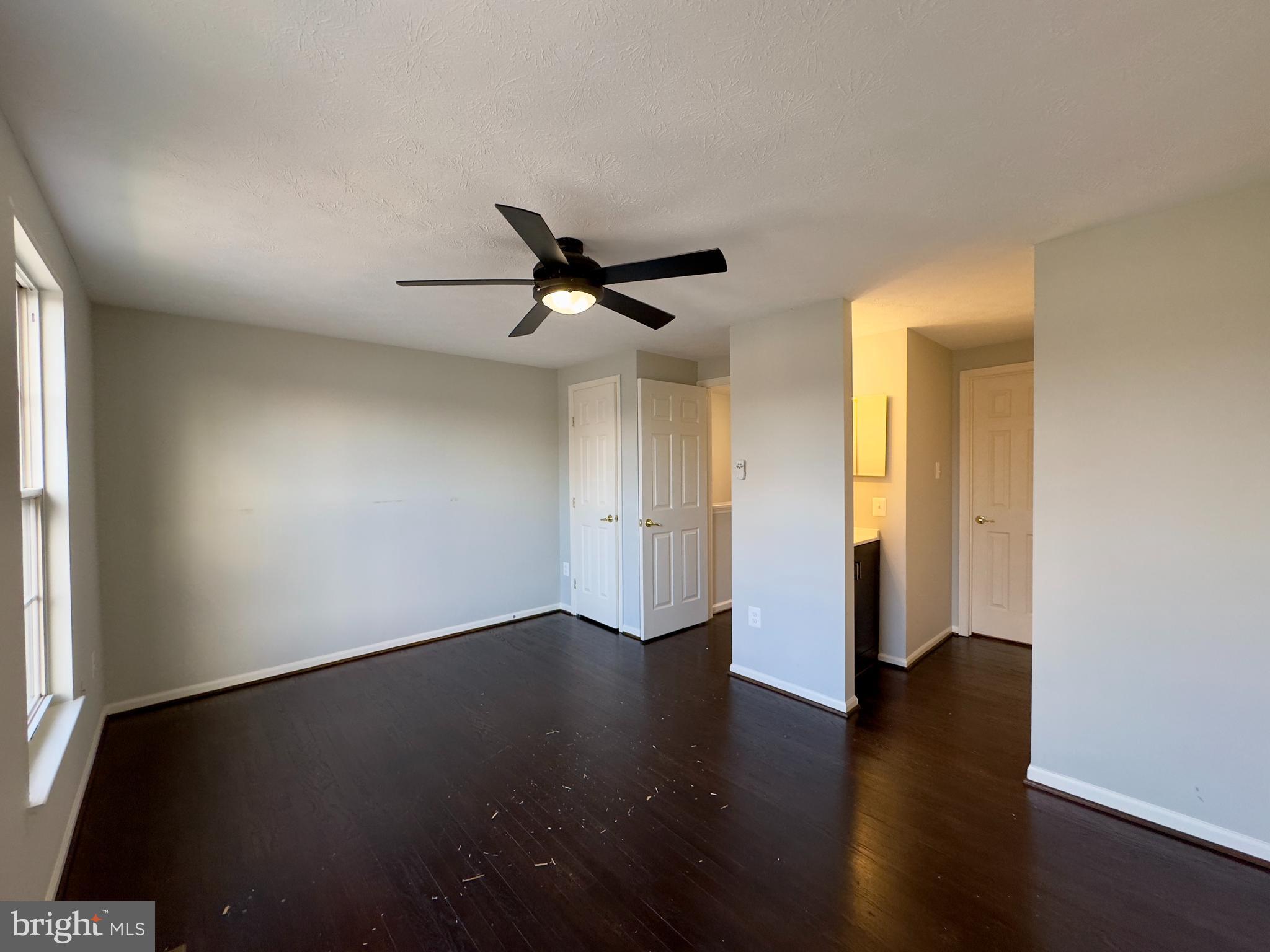 2209 Riding Crop Way Baltimore, MD 21244 - Photo 5 of 20 a view of an empty room with wooden floor and a window
