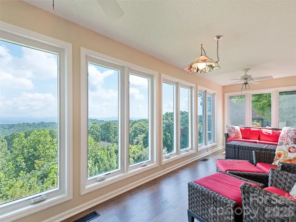 a living room with furniture and a floor to ceiling window