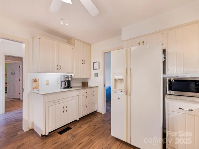 a kitchen with stainless steel appliances a refrigerator sink and cabinets