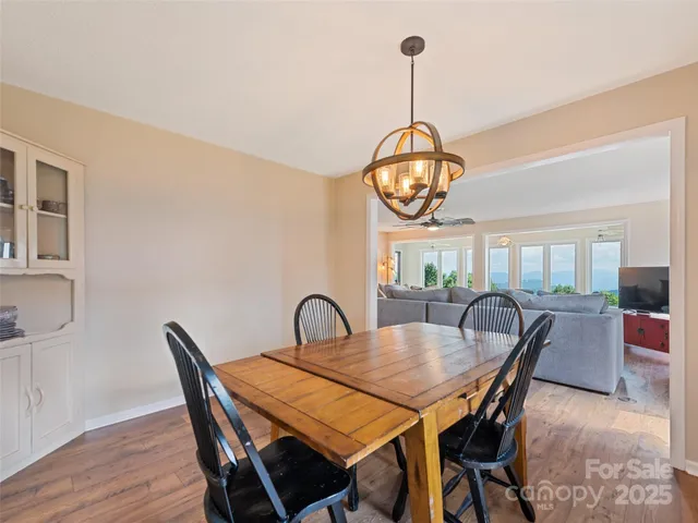 a view of a dining room with furniture wooden floor and chandelier