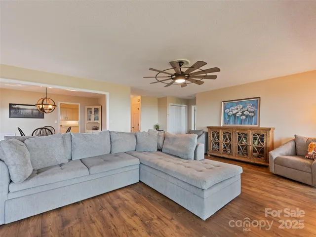 a living room with furniture and a chandelier