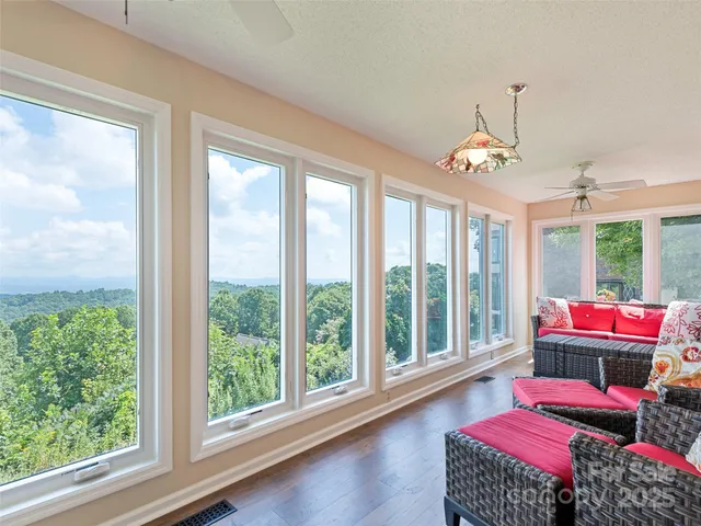 a living room with furniture and a floor to ceiling window