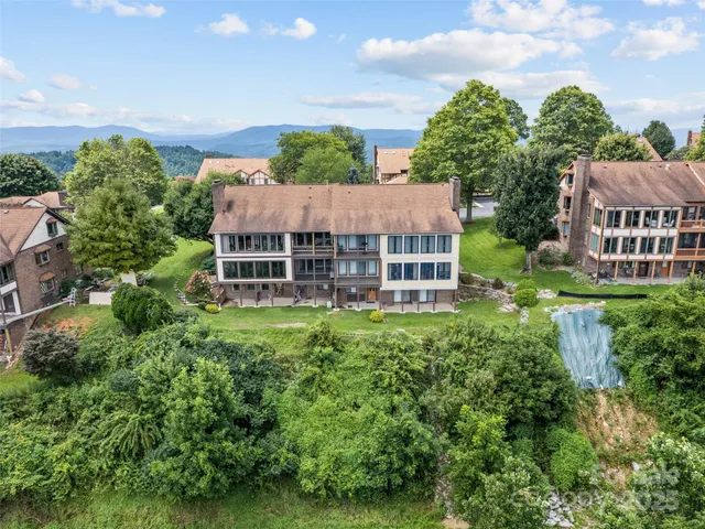 an aerial view of a house with a garden space and street view