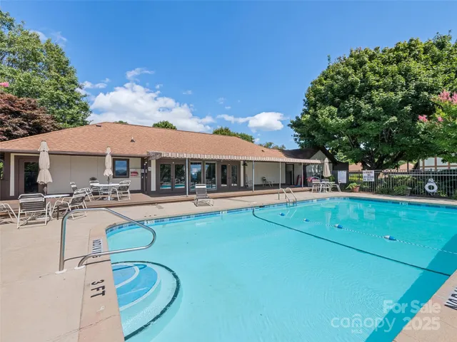 a view of a house with swimming pool and sitting area