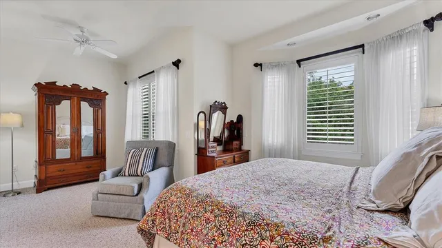 a bedroom with a large bed and a large window