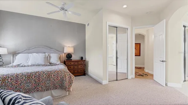 a bedroom with a large bed and a chandelier