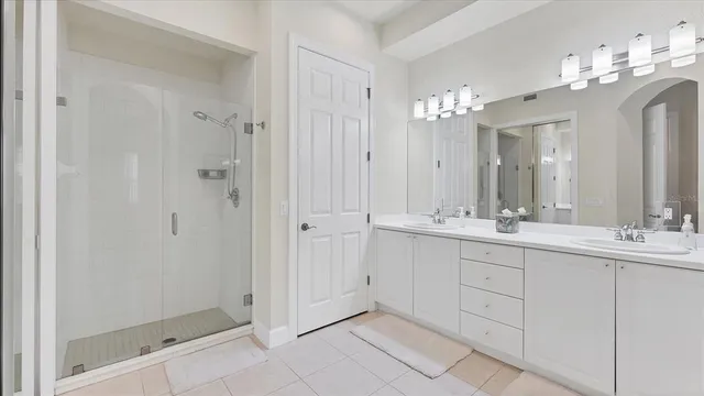 a bathroom with a double vanity sink and a mirror
