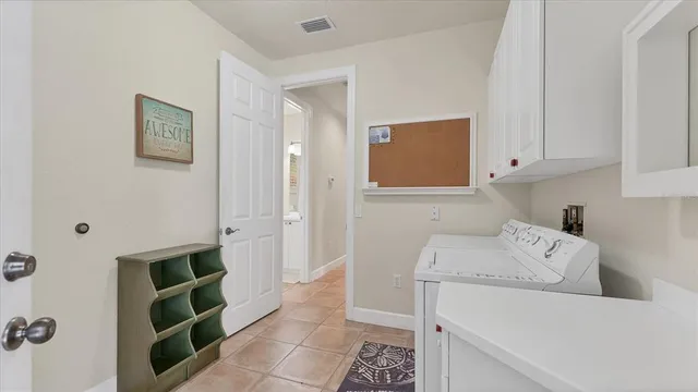 a hallway with a washer and dryer