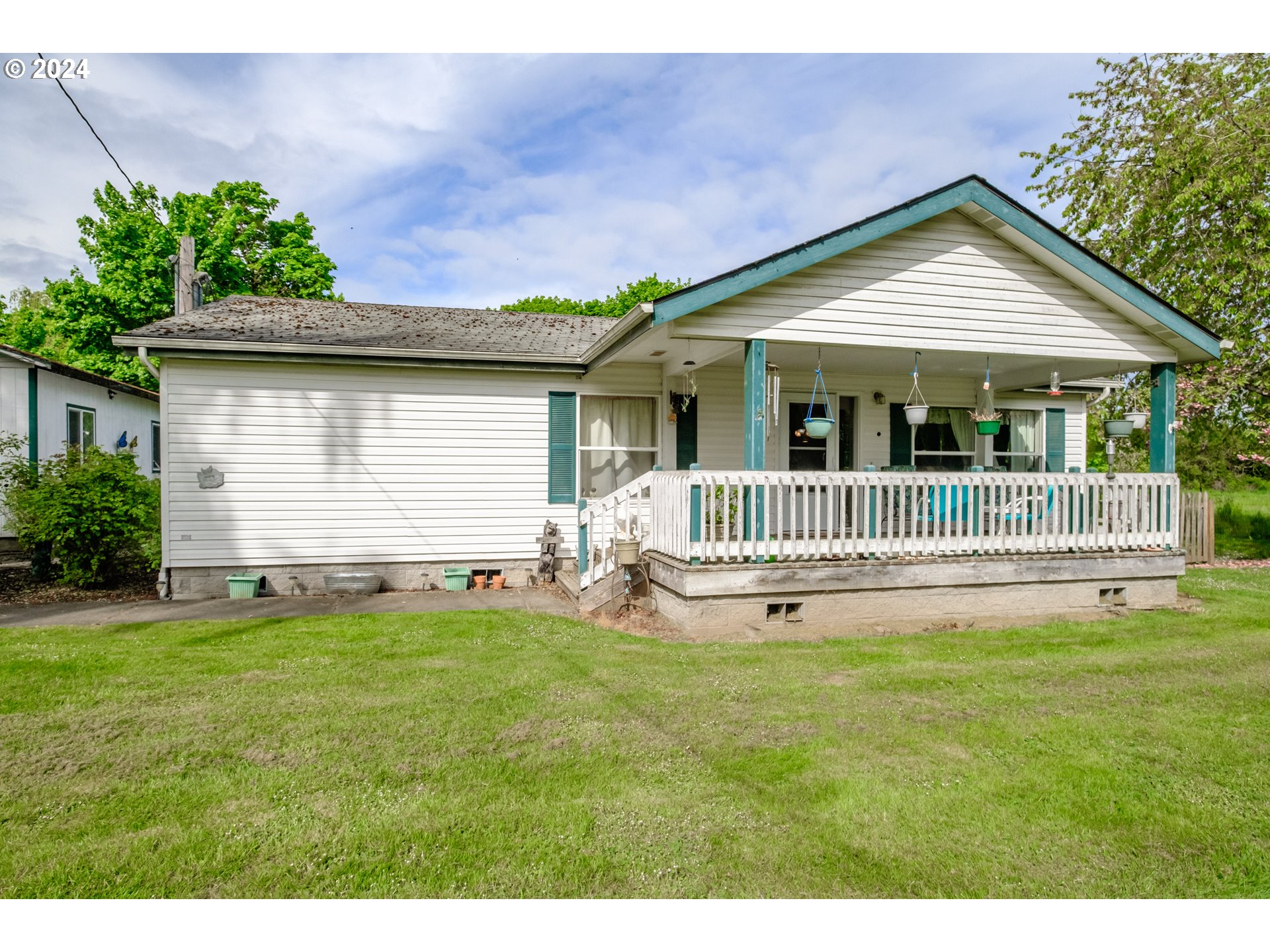 8560 Southeast Wallace Road Dayton, OR 97114 - Photo 13 of 48 a view of a house with a yard and a garden
