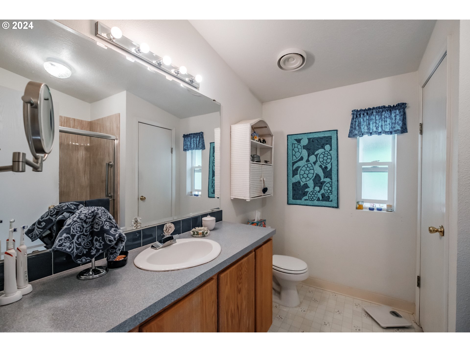 8560 Southeast Wallace Road Dayton, OR 97114 - Photo 26 of 48 a bathroom with a double vanity sink a toilet and a mirror