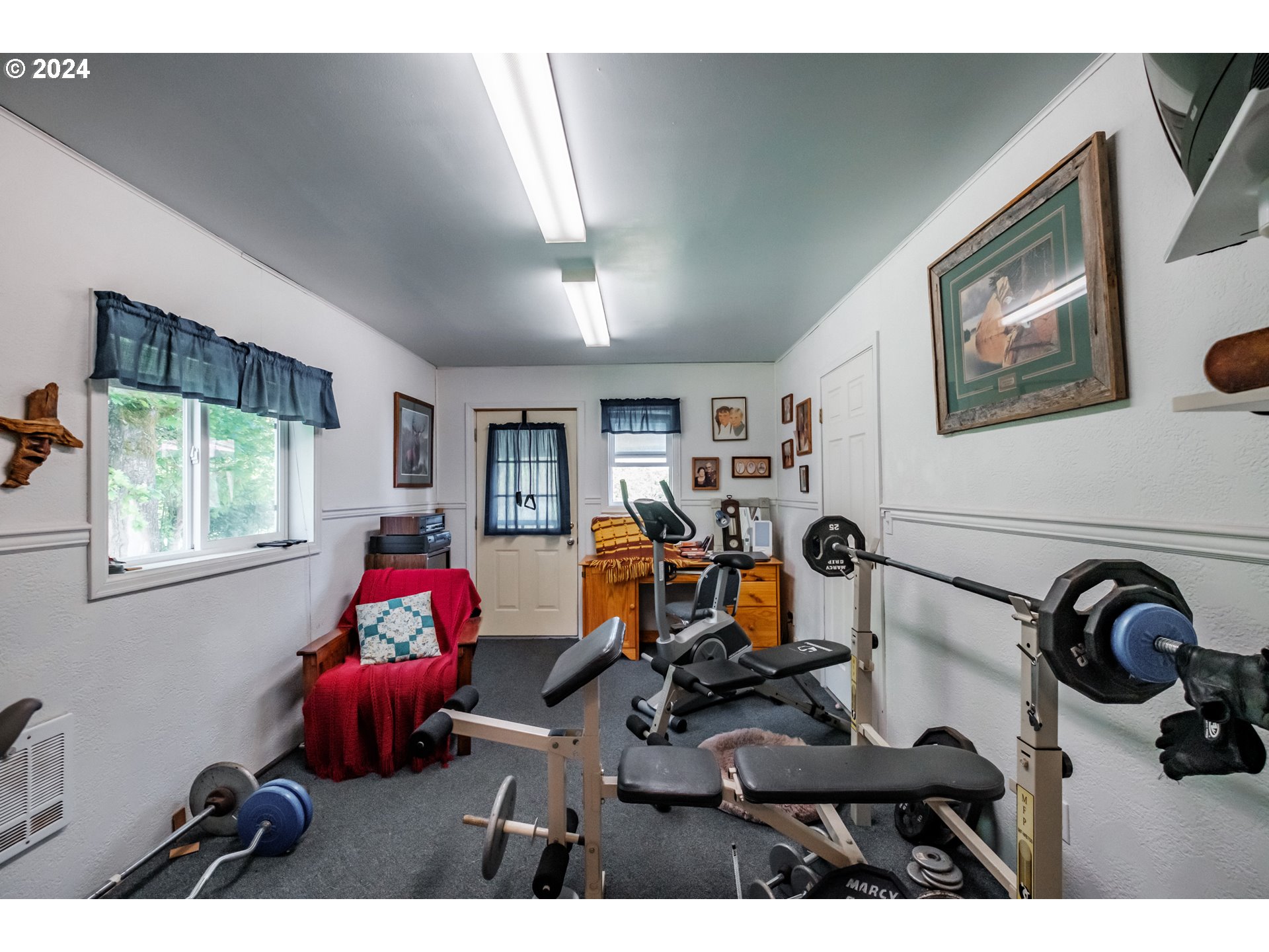 8560 Southeast Wallace Road Dayton, OR 97114 - Photo 43 of 48 a living room with furniture a window and gym equipment