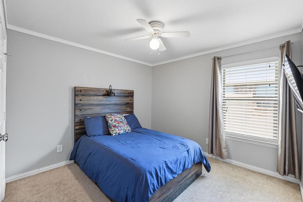 100 Turtle Dove Krum, TX 76249 - Photo 11 of 40 a bedroom with a bed and window