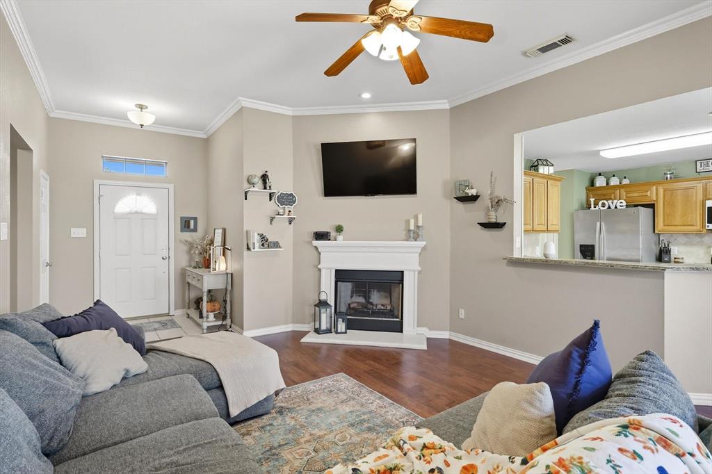 100 Turtle Dove Krum, TX 76249 - Photo 17 of 40 a living room with furniture a flat screen tv and a fireplace