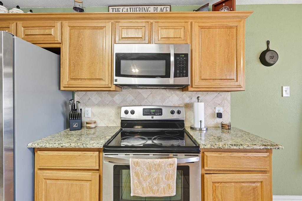 100 Turtle Dove Krum, TX 76249 - Photo 22 of 40 a stove top oven sitting inside of a kitchen