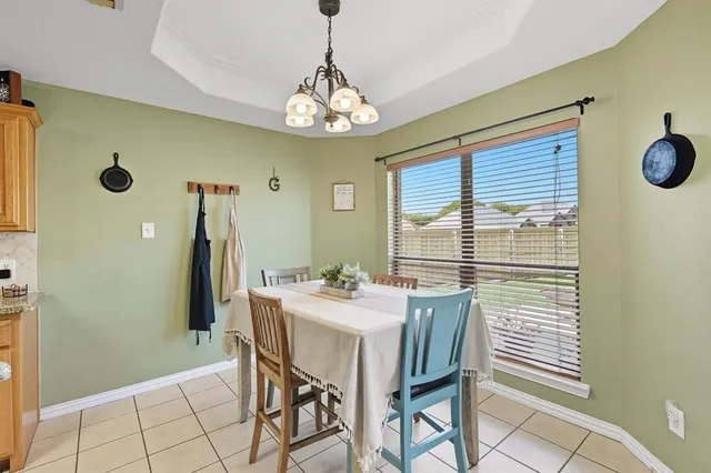 a large kitchen with a table and chairs