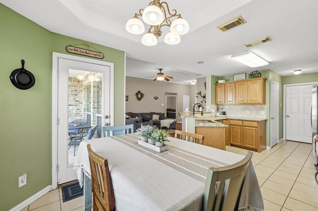 100 Turtle Dove Krum, TX 76249 - Photo 24 of 40 a large kitchen with a table and chairs