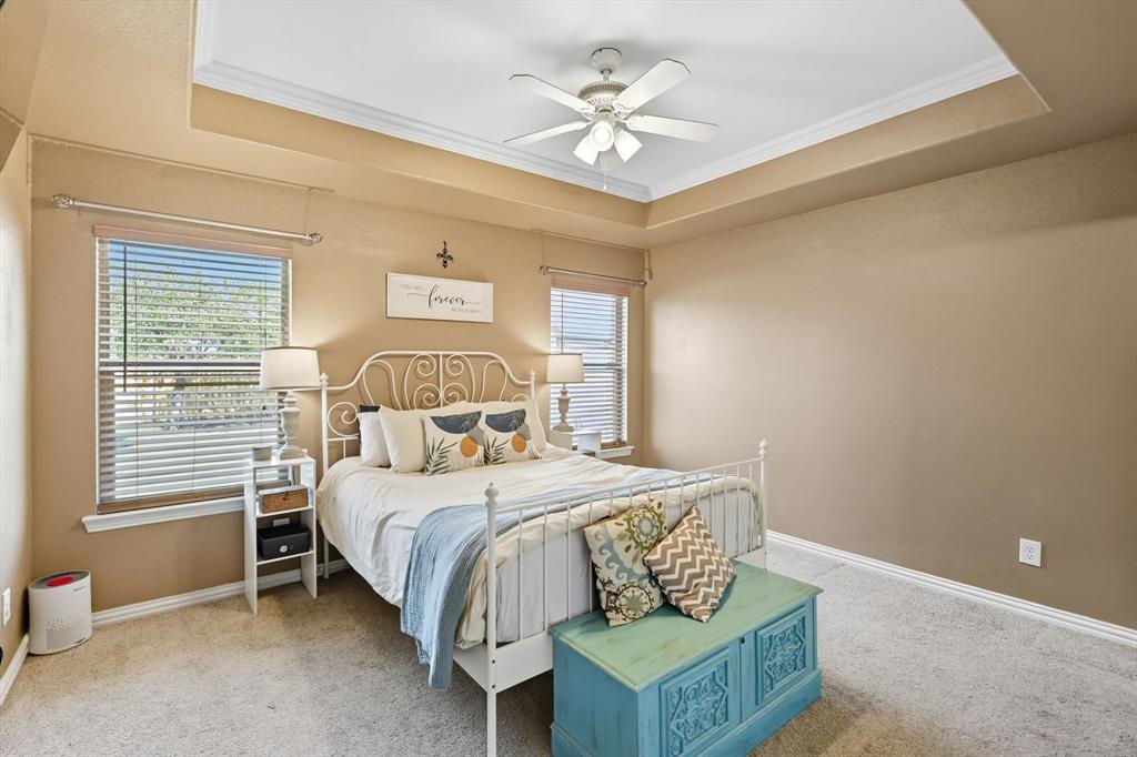 100 Turtle Dove Krum, TX 76249 - Photo 26 of 40 a bedroom with a bed and a chandelier