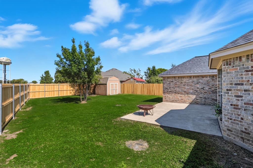 100 Turtle Dove Krum, TX 76249 - Photo 28 of 40 a view of a backyard with a garden