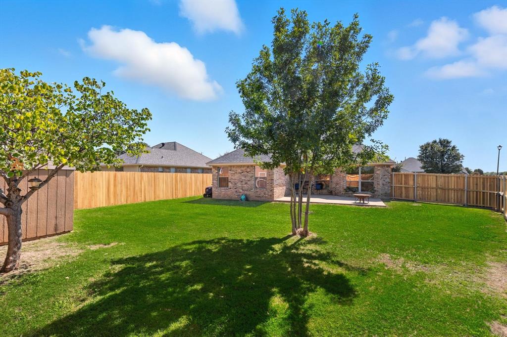 100 Turtle Dove Krum, TX 76249 - Photo 29 of 40 a view of a backyard with a garden
