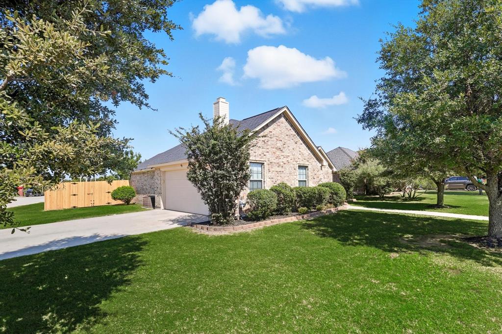 100 Turtle Dove Krum, TX 76249 - Photo 3 of 40 a view of a backyard with garden