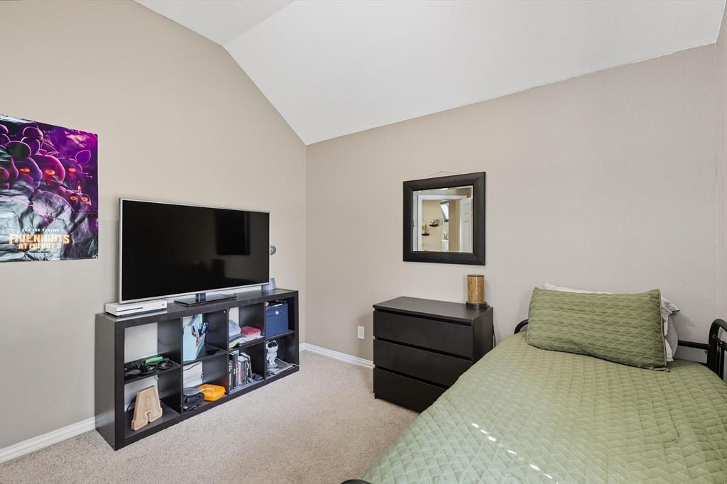 100 Turtle Dove Krum, TX 76249 - Photo 9 of 40 a bedroom with furniture and a flat screen tv