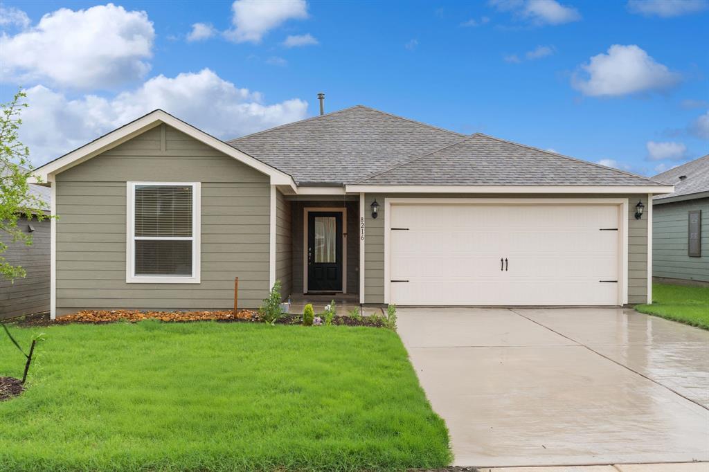 8216 Columbia Falls Road Ponder, TX 76259 - Photo 2 of 28 Ranch-style home with roof with shingles, driveway, a front yard, and a garage