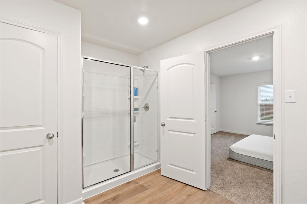 8216 Columbia Falls Road Ponder, TX 76259 - Photo 23 of 28 Bathroom with recessed lighting, wood finished floors, and a stall shower