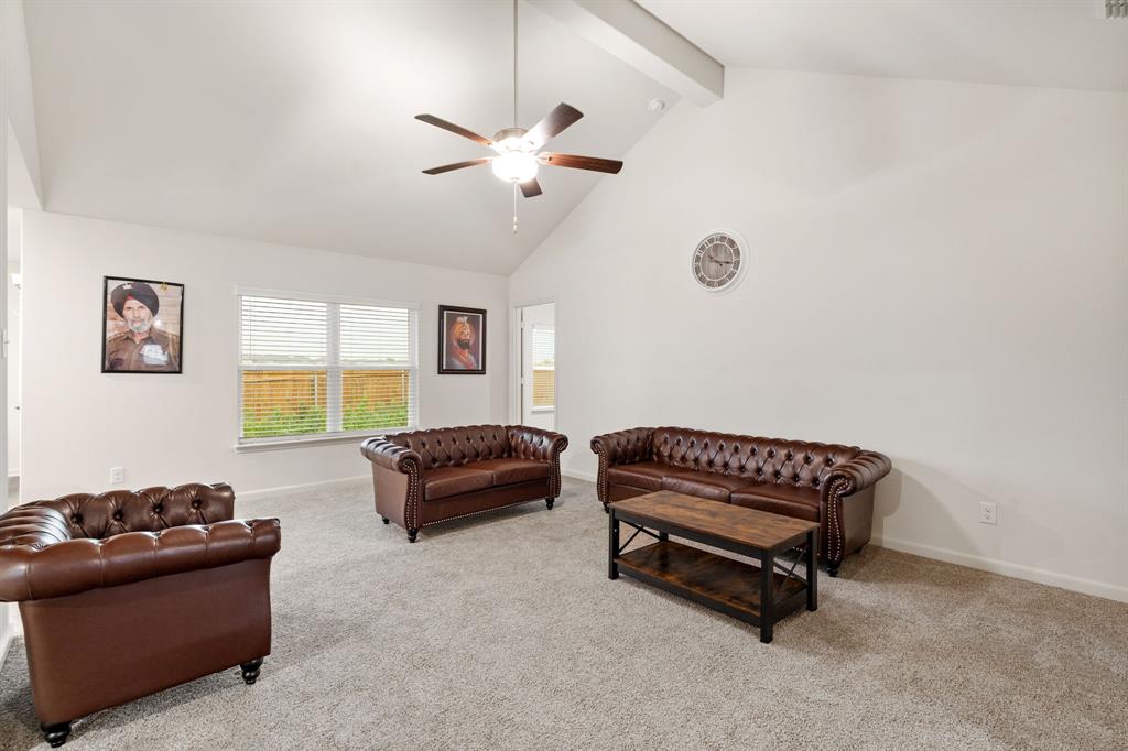 8216 Columbia Falls Road Ponder, TX 76259 - Photo 9 of 28 Living room featuring a ceiling fan, beam ceiling, high vaulted ceiling, baseboards, and carpet